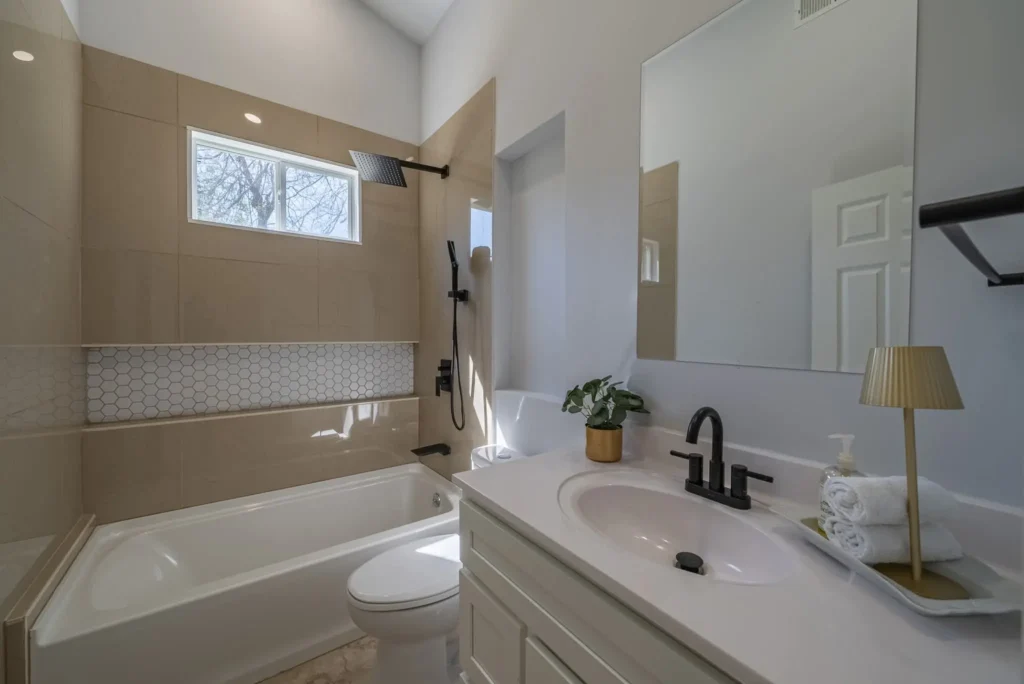 Yo, check out this sleek bathroom! A shiny new tub, modern sink, and fresh plumbing upgrades shine with a stylish faucet and tile. Our pros bring top-notch updates to life!